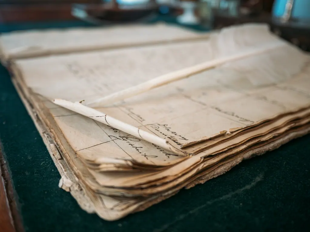 Ruled ledger pages and accounting records, used as context imagery.