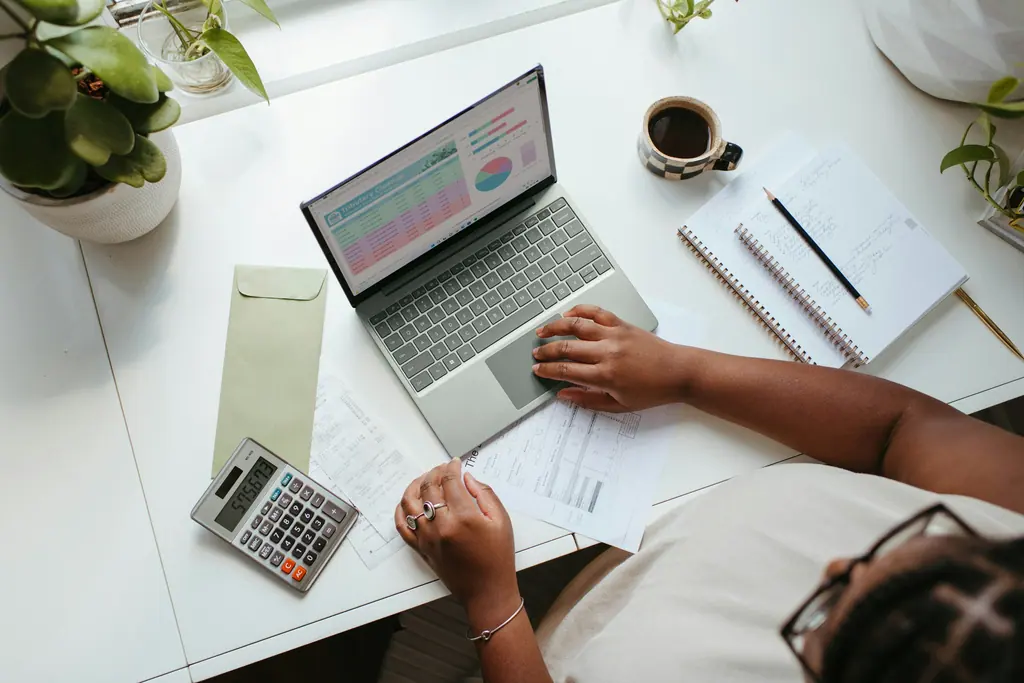 Year-end accounting documents and a laptop on a desk, used as context imagery.