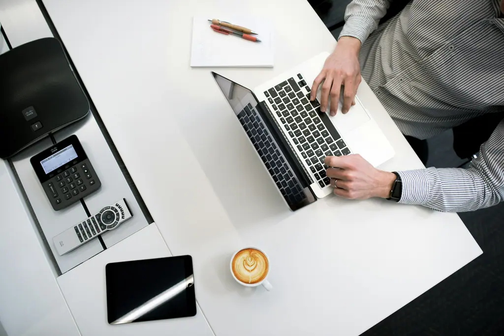 Accounting workspace with printed financial statements, a laptop and a pen, used as context imagery.