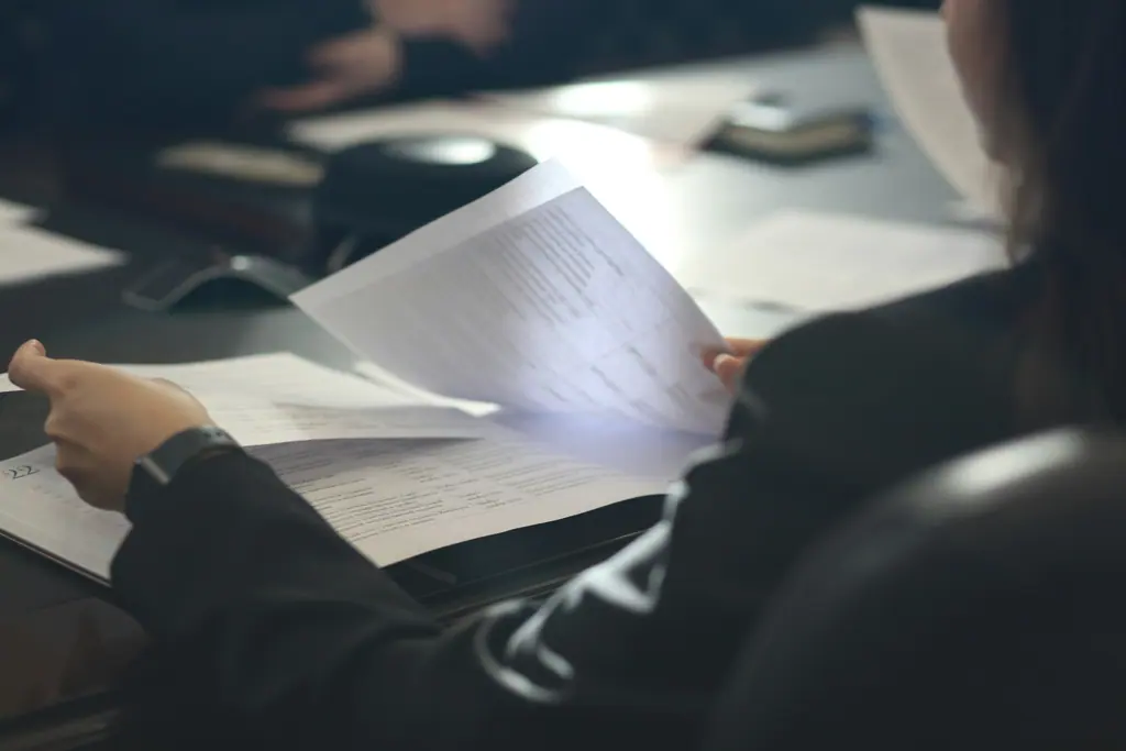 Finance documents organised across an office desk, used as context imagery.