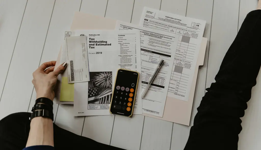 Tax planning notes, a calculator and reference paperwork, used as context imagery.